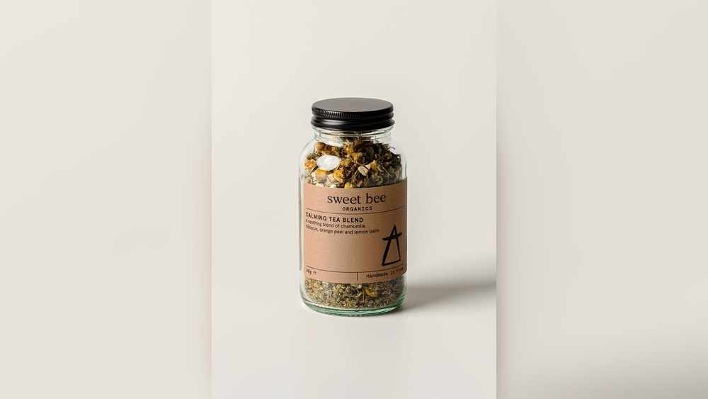 Sweet Bee Organics Calming Tea Blend in glass jar, featuring chamomile, orange peel, and lemon balm.