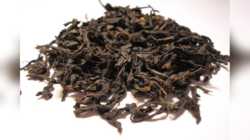 Dried Dahongpao oolong tea leaves, showcasing their dark, twisted appearance.