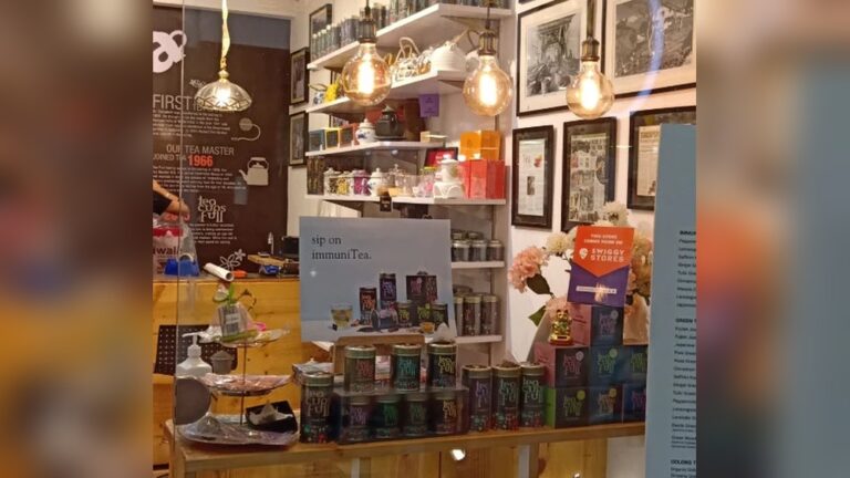 Tea shop display with various tea tins, boxes, and light bulbs