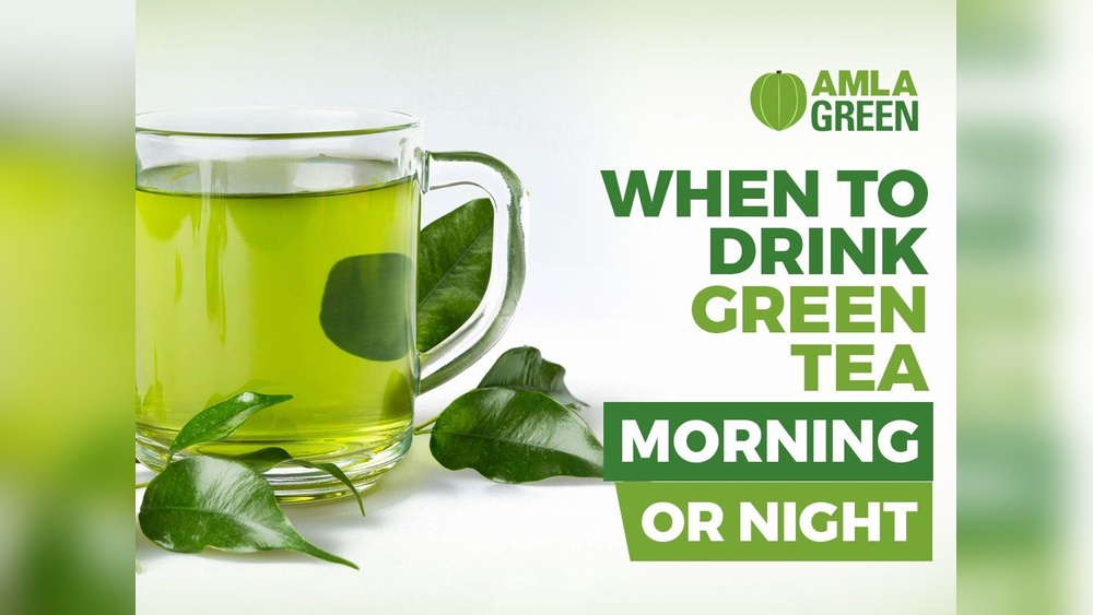 Amla Green tea in a glass mug with fresh leaves. When to drink green tea: Morning or Night.