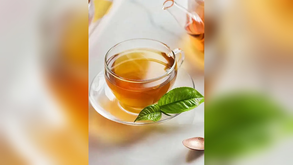 Cup of Lipton black tea with fresh leaves, perfect for boosting energy.