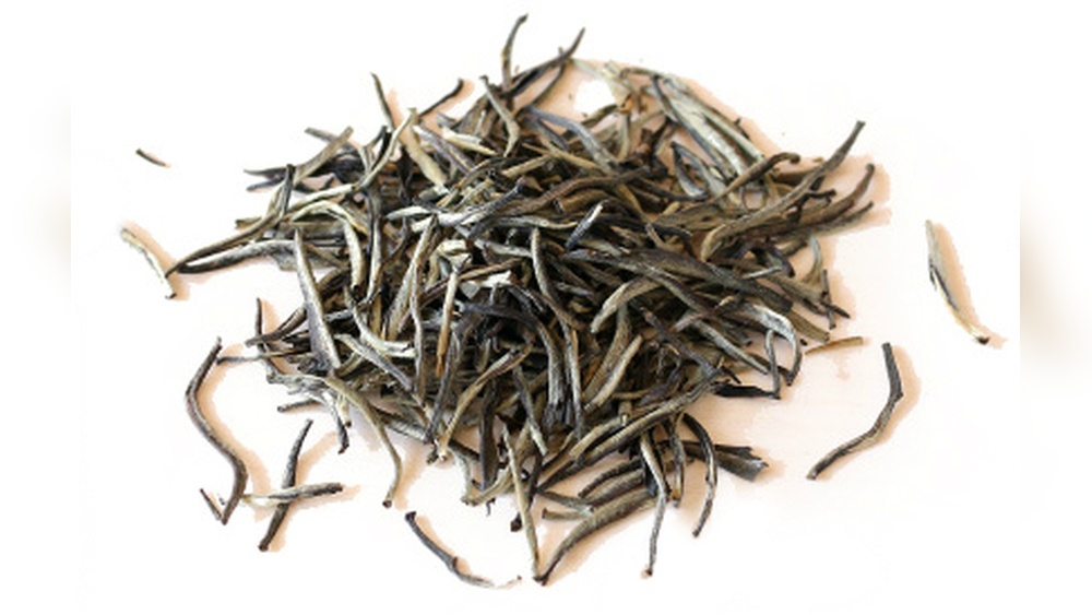 Close-up of delicate white tea leaves, showcasing their natural beauty and purity.