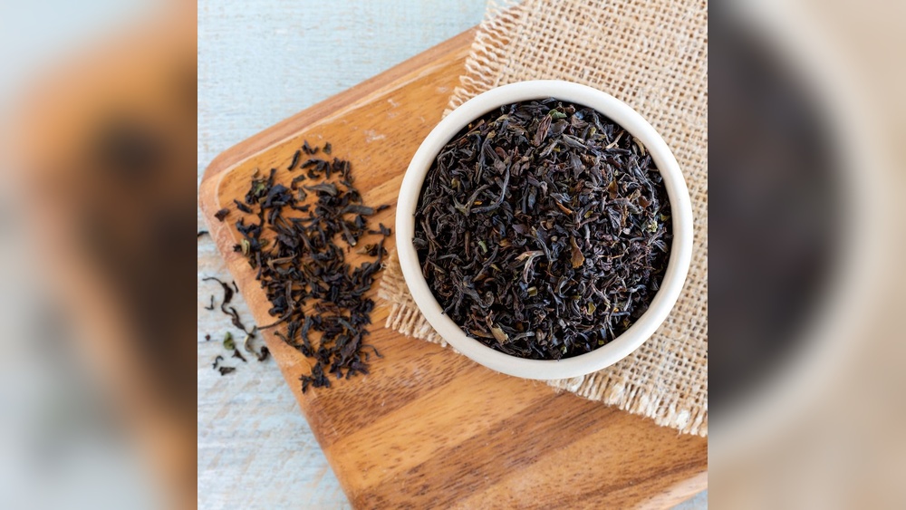 Loose black tea and orange pekoe tea leaves in a bowl